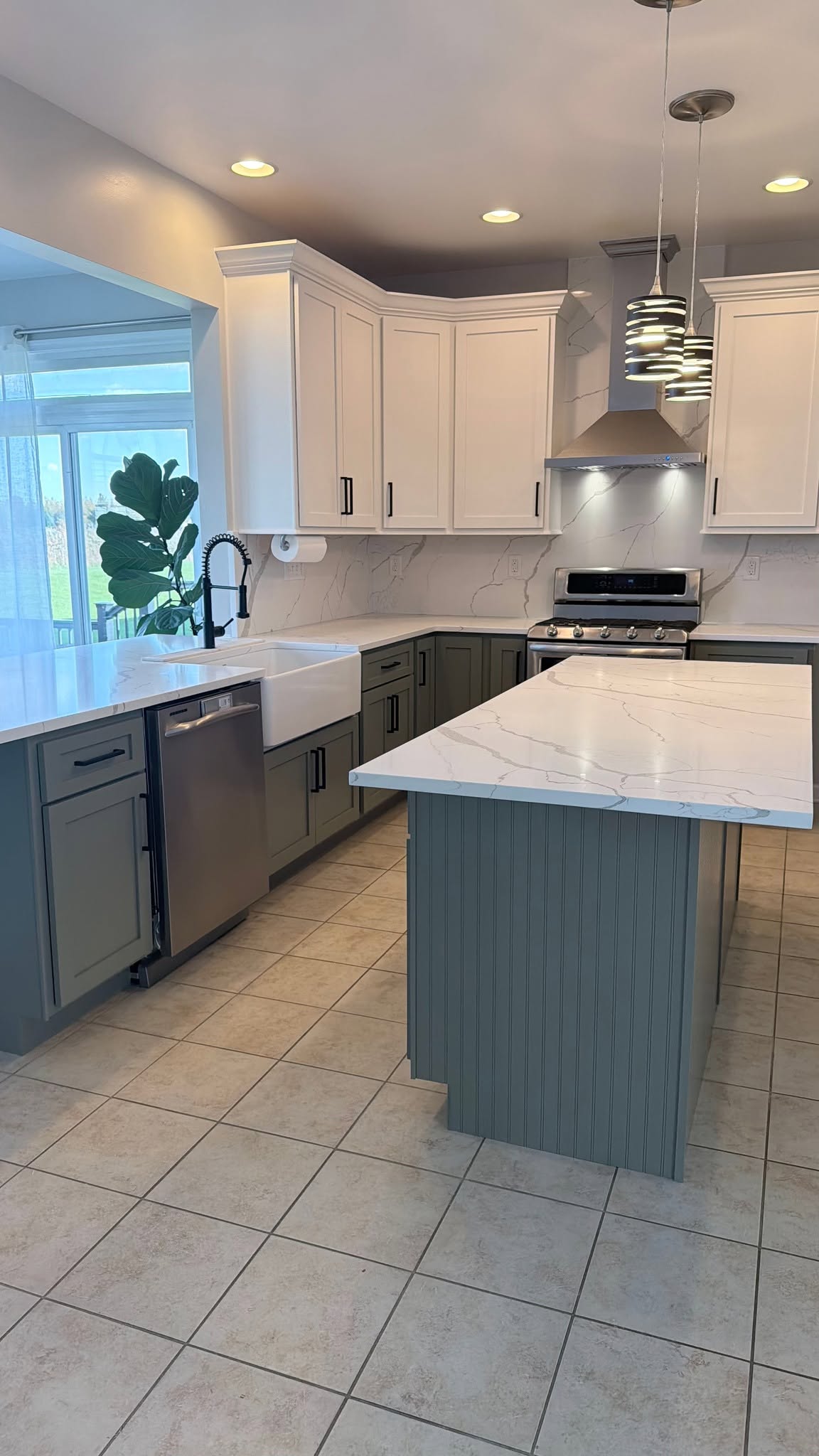 Custom white kitchen with quartz countertops by Orozco's Granite